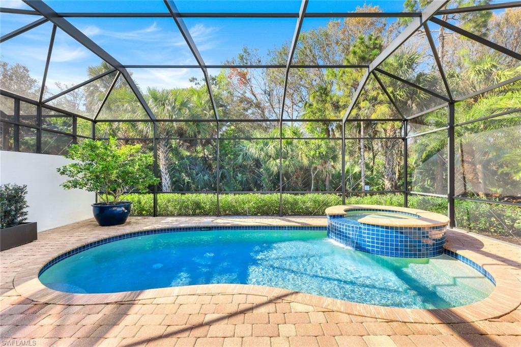6573 Roma Way Naples, FL 34113 - Photo 31 of 49 View of pool with an in ground hot tub, glass enclosure, and a patio