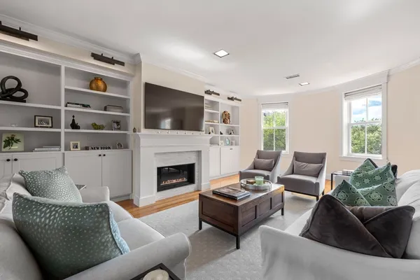 a living room with furniture fireplace and flat screen tv