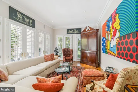 a living room with furniture and a floor to ceiling window