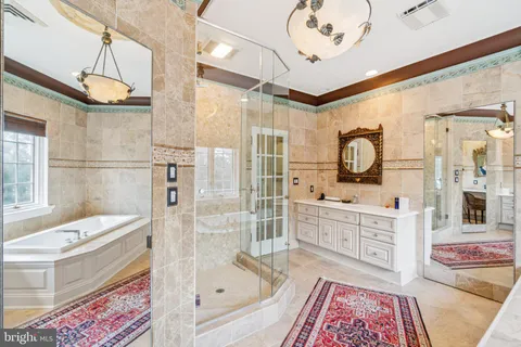 a bathroom with a tub sink and mirror