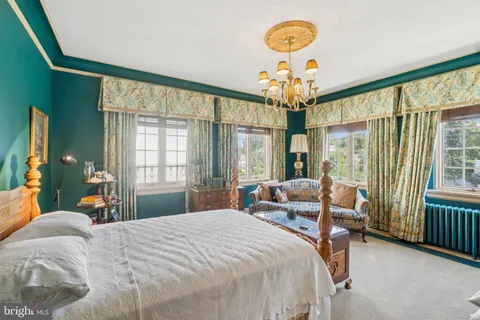 a bedroom with a bed and a large window