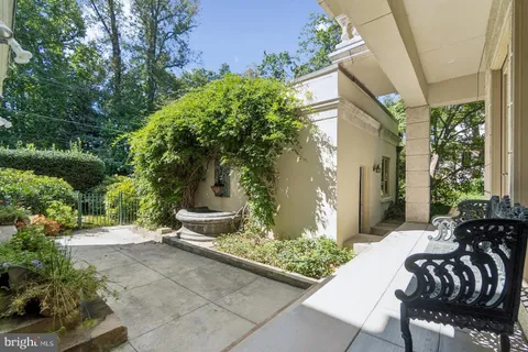 a view of a patio with couches table and chairs and potted plants