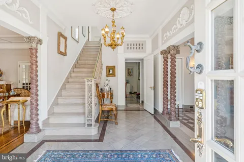 a view of an entryway with wooden floor and a chandelier