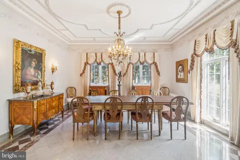 a view of a dining room with furniture and chandelier