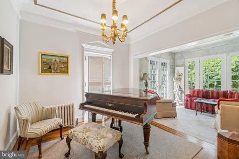 a living room with patio furniture and a large window