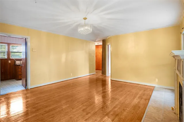 wooden floor in an empty room with a window