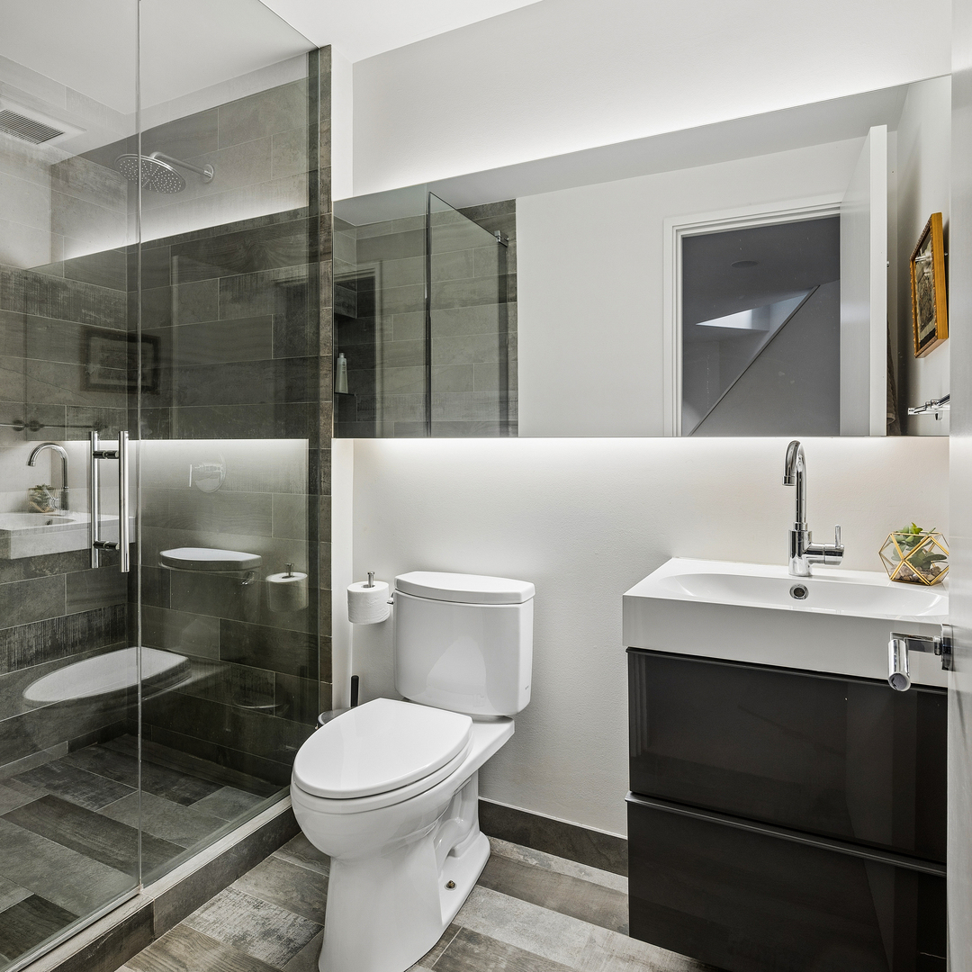 2249 North Burling Street Chicago, IL 60614 - Photo 40 of 41 a bathroom with a toilet a sink and mirror