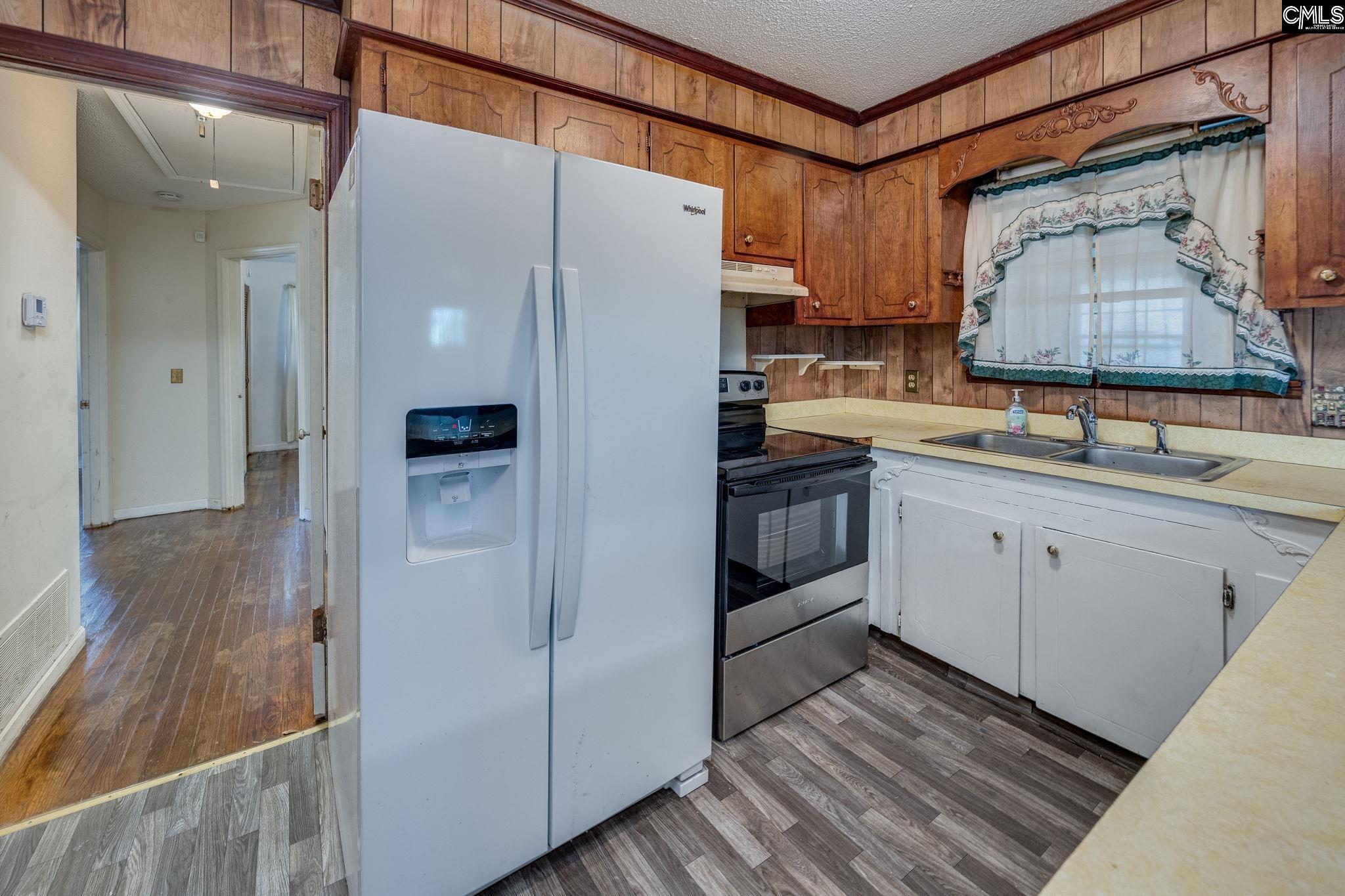 5666 Middleton Court Columbia, SC 29203 - Photo 20 of 42 a kitchen with a sink a refrigerator and cabinets