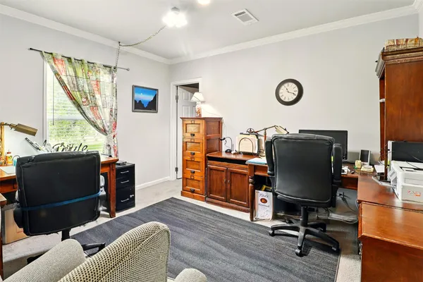 a view of a livingroom with workspace and a window