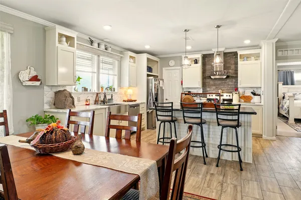 a view of a dining room with furniture and wooden floor