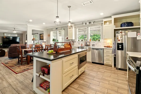 a kitchen with stainless steel appliances granite countertop a stove and cabinets