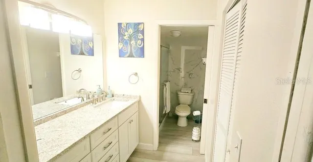 a spacious bathroom with a granite countertop sink mirror and a