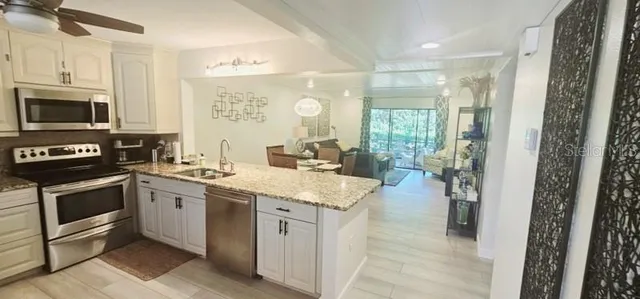 a kitchen with a sink stove and cabinets