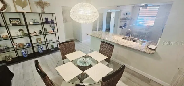 a view of a dining room with furniture a rug and wooden floor