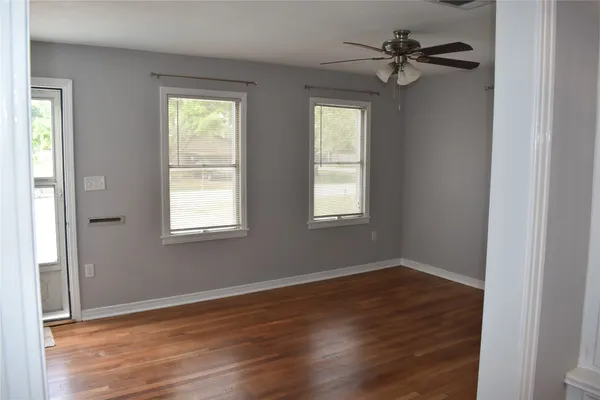wooden floor in an empty room with a window