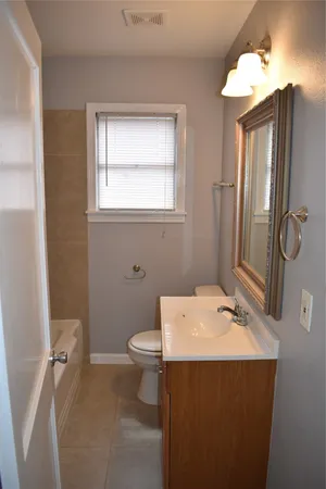 a bathroom with a sink toilet and mirror