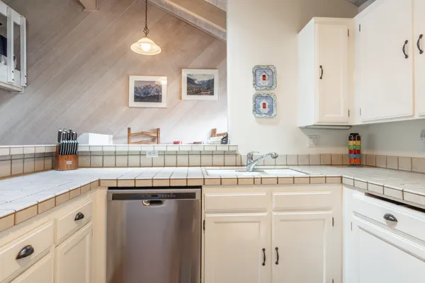 a kitchen with stainless steel appliances granite countertop a sink and cabinets