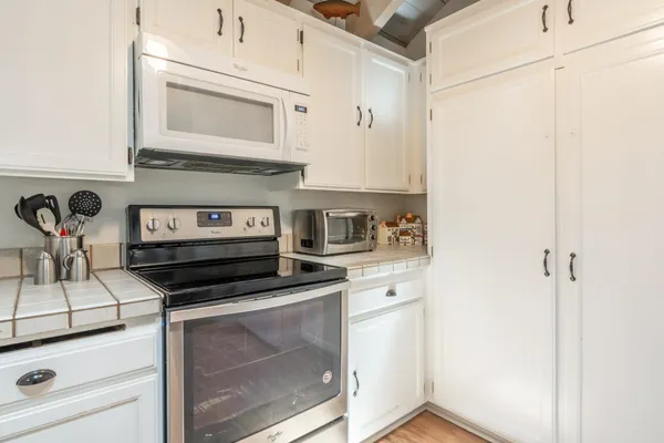 a kitchen with appliances and cabinets