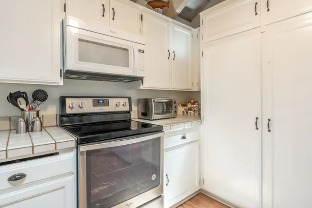 a kitchen with appliances and cabinets