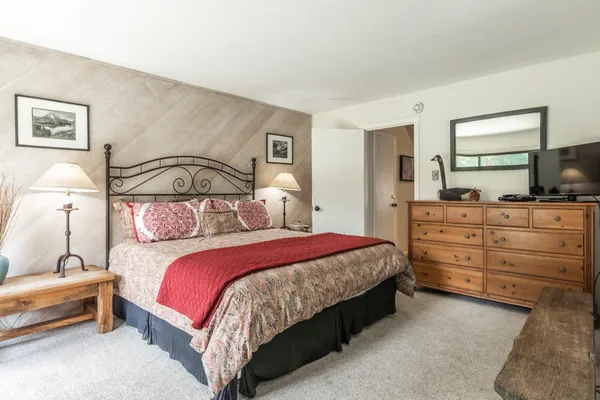 a bedroom with a bed and window