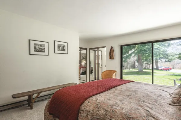 a bedroom with a bed and a large window