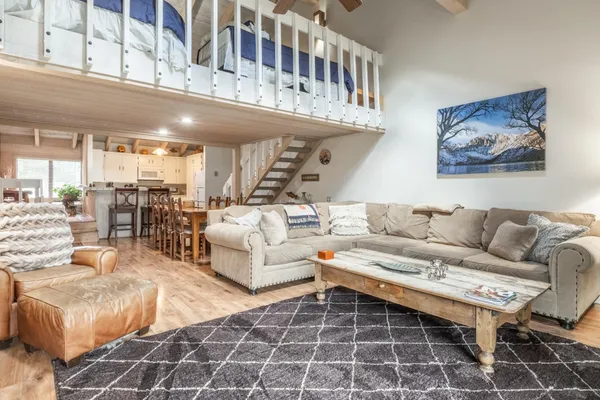 a living room with furniture a fireplace and a chandelier