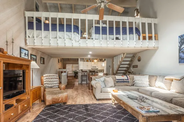 a living room with furniture a flat screen tv and a fireplace