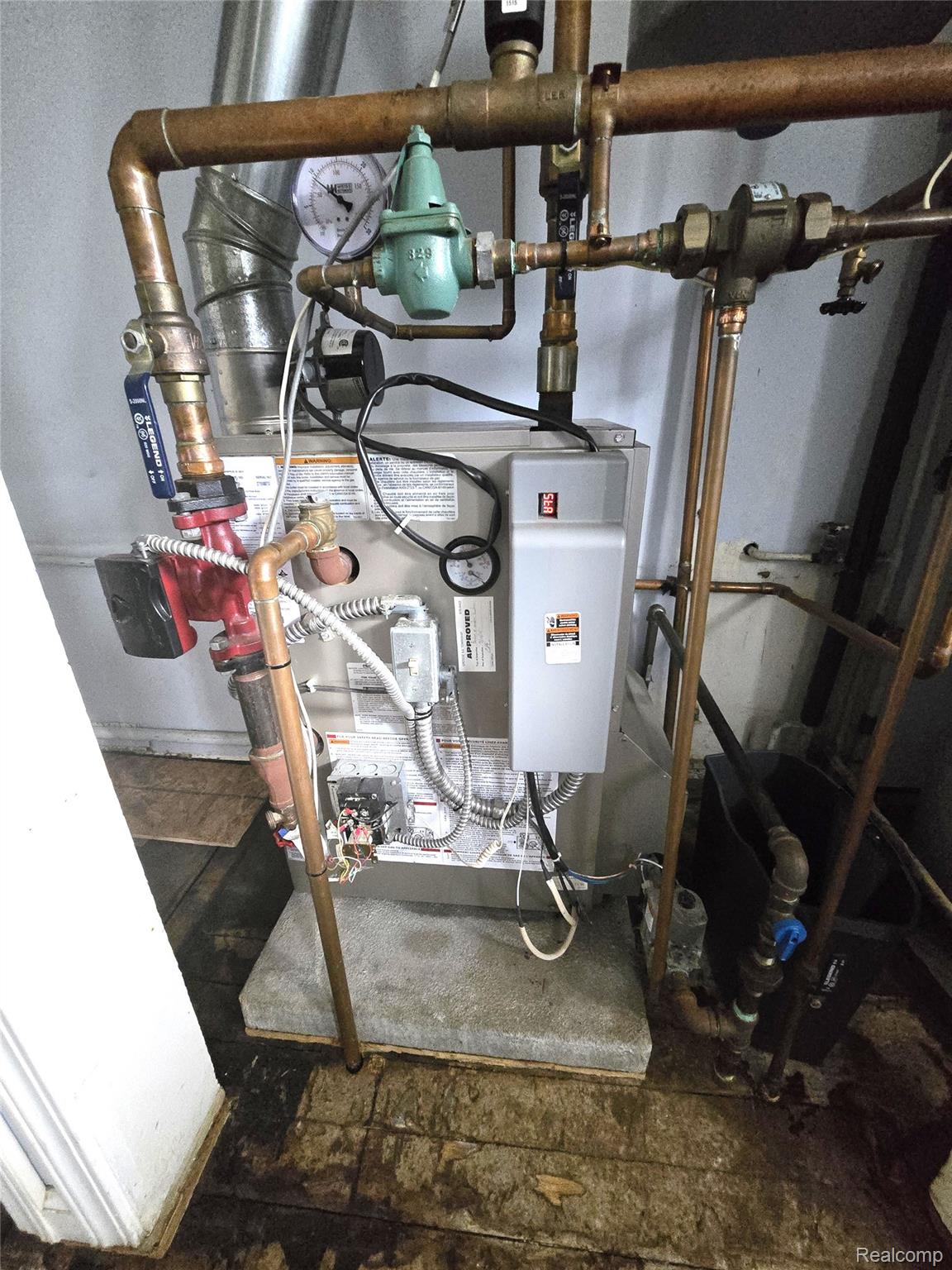 7993 Church Road Grosse Ile, MI 48138 - Photo 19 of 37 Central heating system featuring copper piping and a gray utility box on a concrete pad