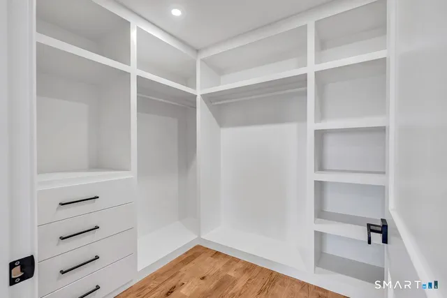 a view of walk in closet with empty racks