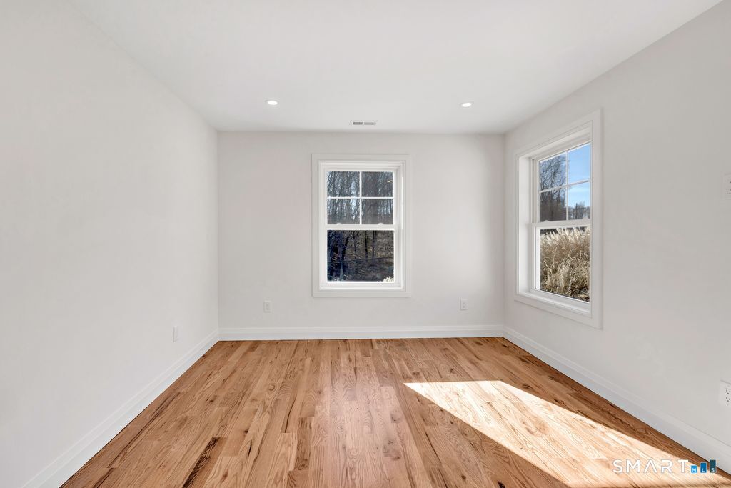 100 Tashua Road Trumbull, CT 06611 - Photo 13 of 26 an empty room with wooden floor and windows
