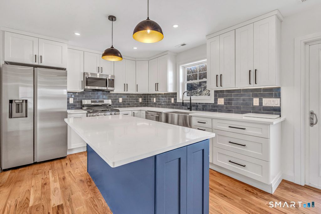 100 Tashua Road Trumbull, CT 06611 - Photo 19 of 26 a kitchen with stainless steel appliances granite countertop a stove a sink and a refrigerator
