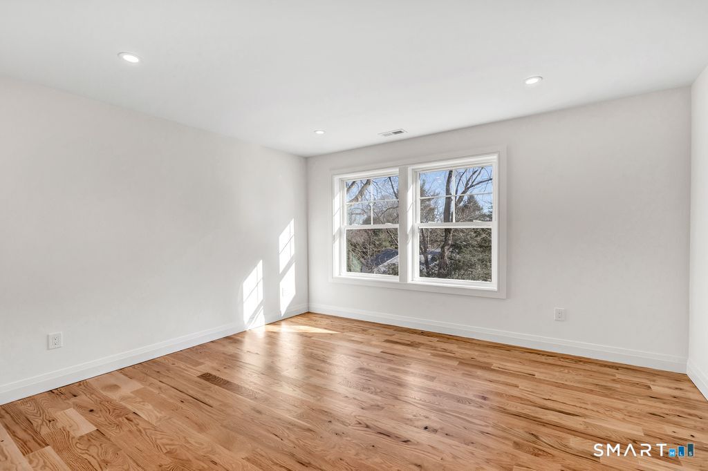 100 Tashua Road Trumbull, CT 06611 - Photo 21 of 26 a view of an empty room with wooden floor and a window