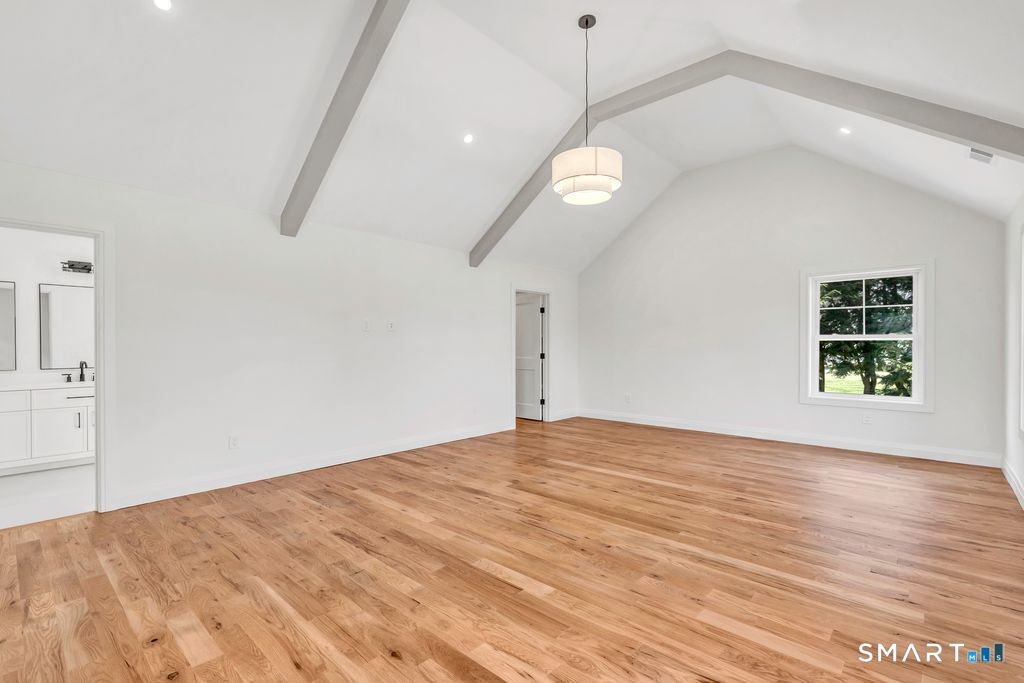 100 Tashua Road Trumbull, CT 06611 - Photo 5 of 26 a view of an empty room with a window and wooden floor