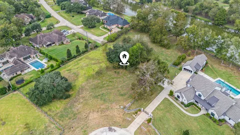 an aerial view of a house with swimming pool and garden