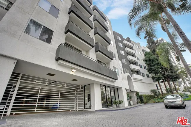 a view of building with car parked