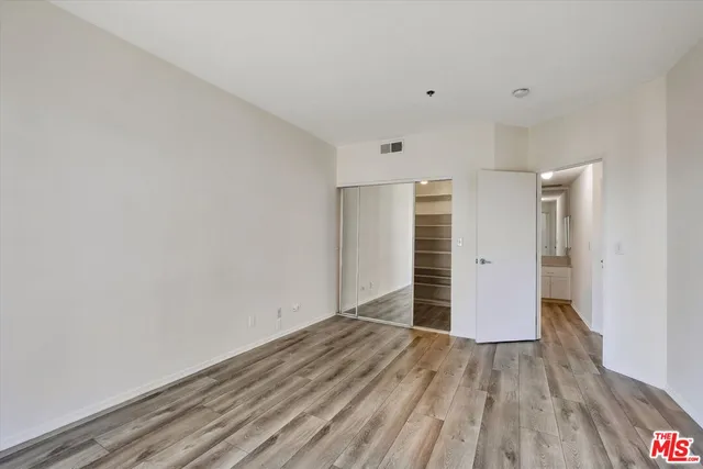 a view of a room with wooden floor and window