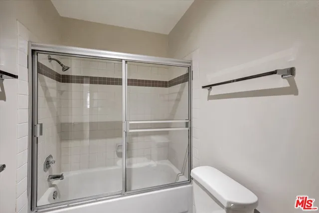 a bathroom with a shower and toilet