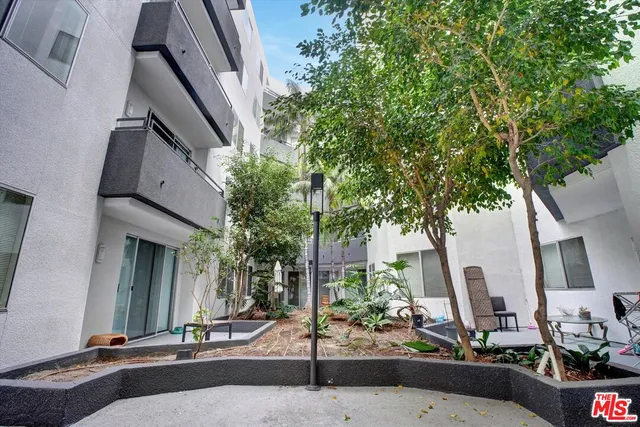 a building exterior with tall trees