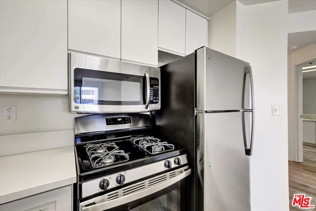 a kitchen with a stove and a microwave
