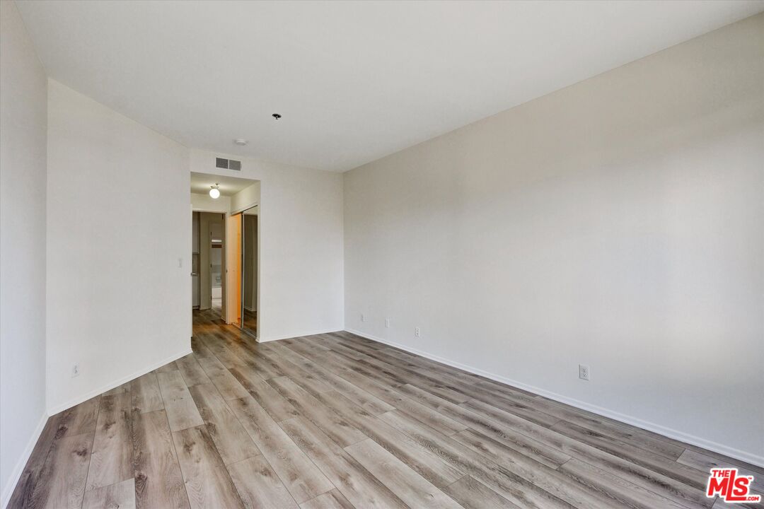 10600 Wilshire Boulevard, Unit 519 Los Angeles, CA 90024 - Photo 7 of 27 a view of an empty room with wooden floor