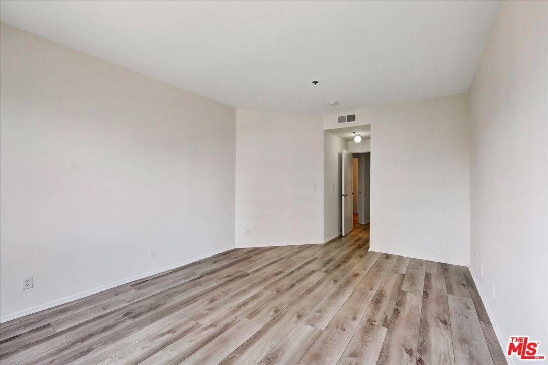 10600 Wilshire Boulevard, Unit 519 Los Angeles, CA 90024 - Photo 8 of 27 a view of empty room with wooden floor and fan