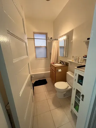 a bathroom with a toilet a sink and shower