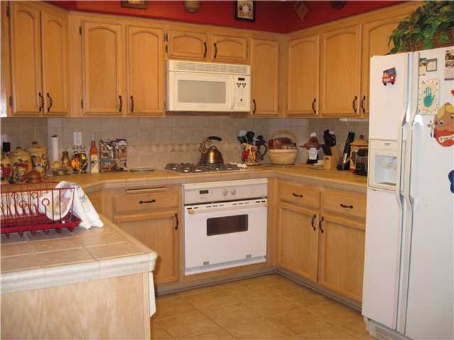 4824 Baroque Terrace Oceanside, CA 92057 - Photo 2 of 24 Nice functional kitchen with upgraded counter and cabinetry.