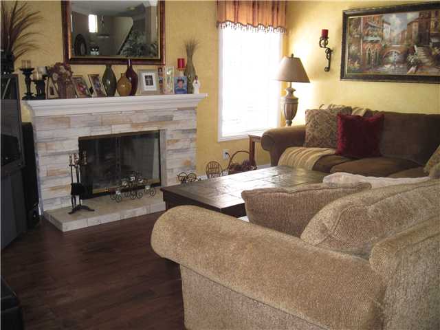 4824 Baroque Terrace Oceanside, CA 92057 - Photo 3 of 24 Cozy family room with redone fireplace and engineered hard wood flooring.