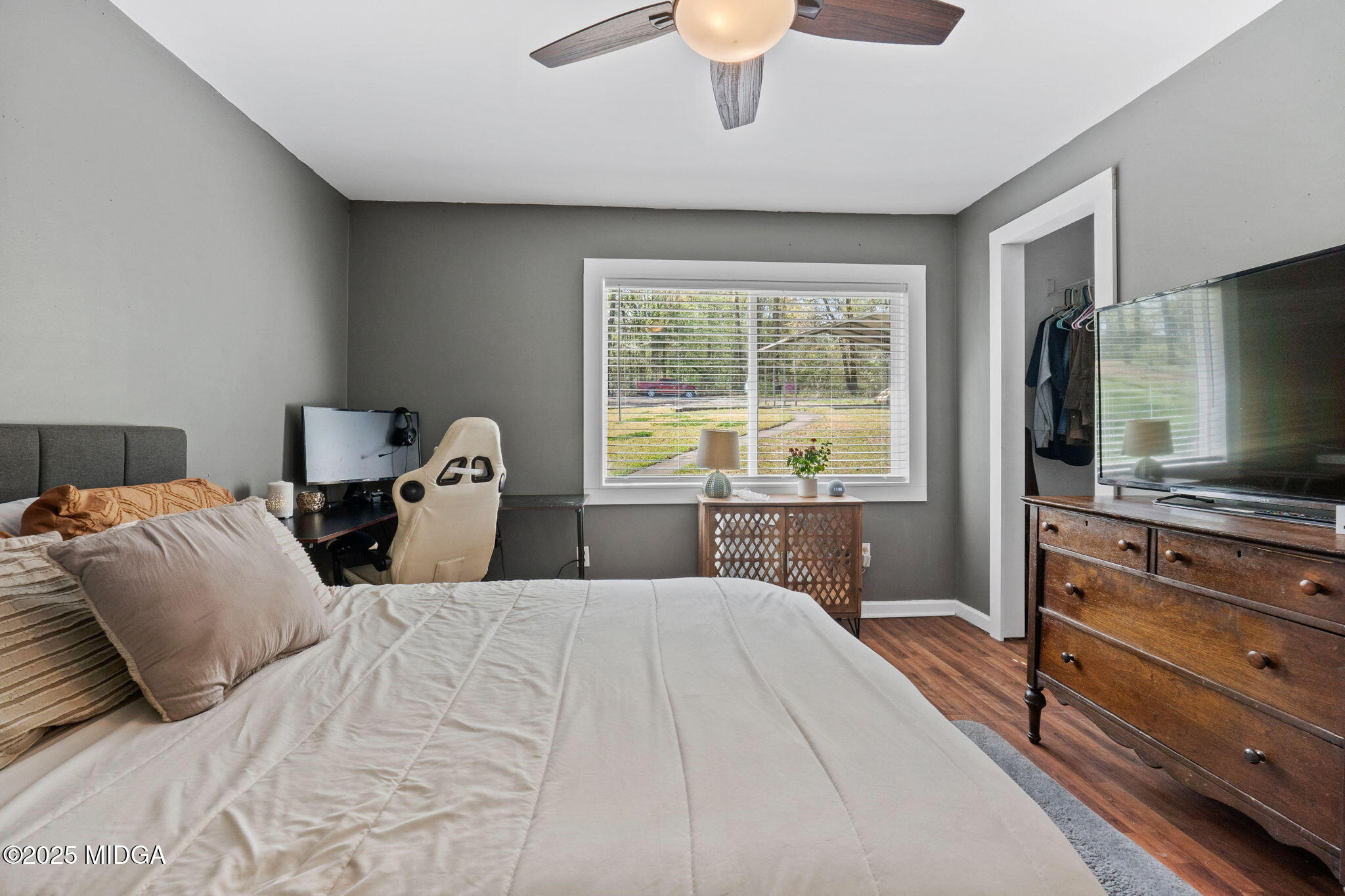 532 Henry Higgins Road Jackson, GA 30233 - Photo 16 of 43 a bedroom with a large bed and a flat tv screen on dresser