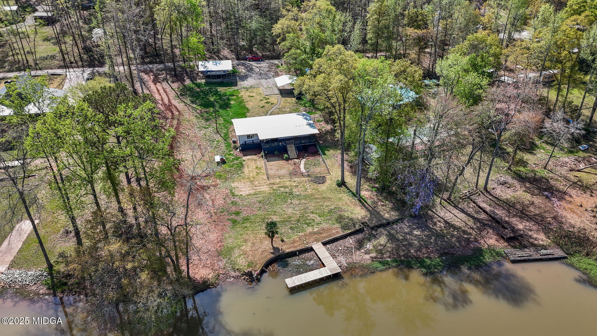 532 Henry Higgins Road Jackson, GA 30233 - Photo 2 of 43 an aerial view of a house with swimming pool and lake view