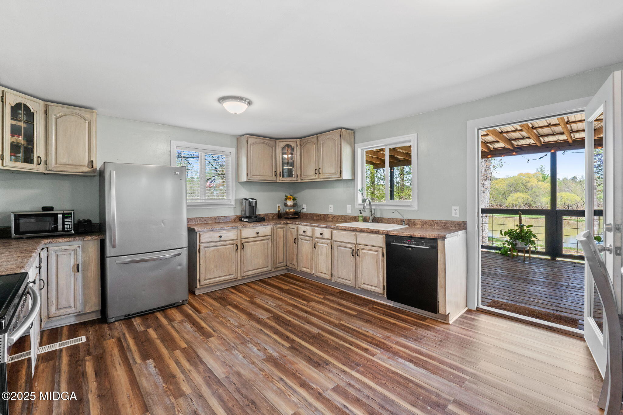 532 Henry Higgins Road Jackson, GA 30233 - Photo 10 of 43 a kitchen with a refrigerator and wooden floor