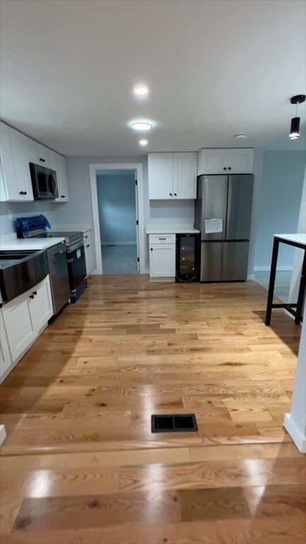 308 East Main Street Orange, MA 01364 - Photo 7 of 21 a large white kitchen with kitchen island a sink stainless steel appliances and cabinets