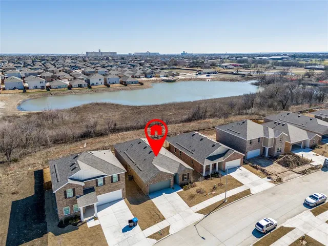 an aerial view of a houses with ocean view