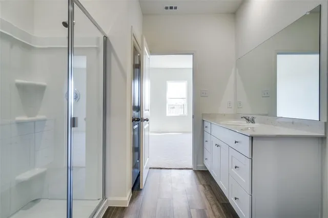 a bathroom with a granite countertop sink a toilet and a large mirror